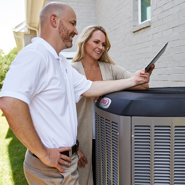 HVAC Technician assisting homeowner